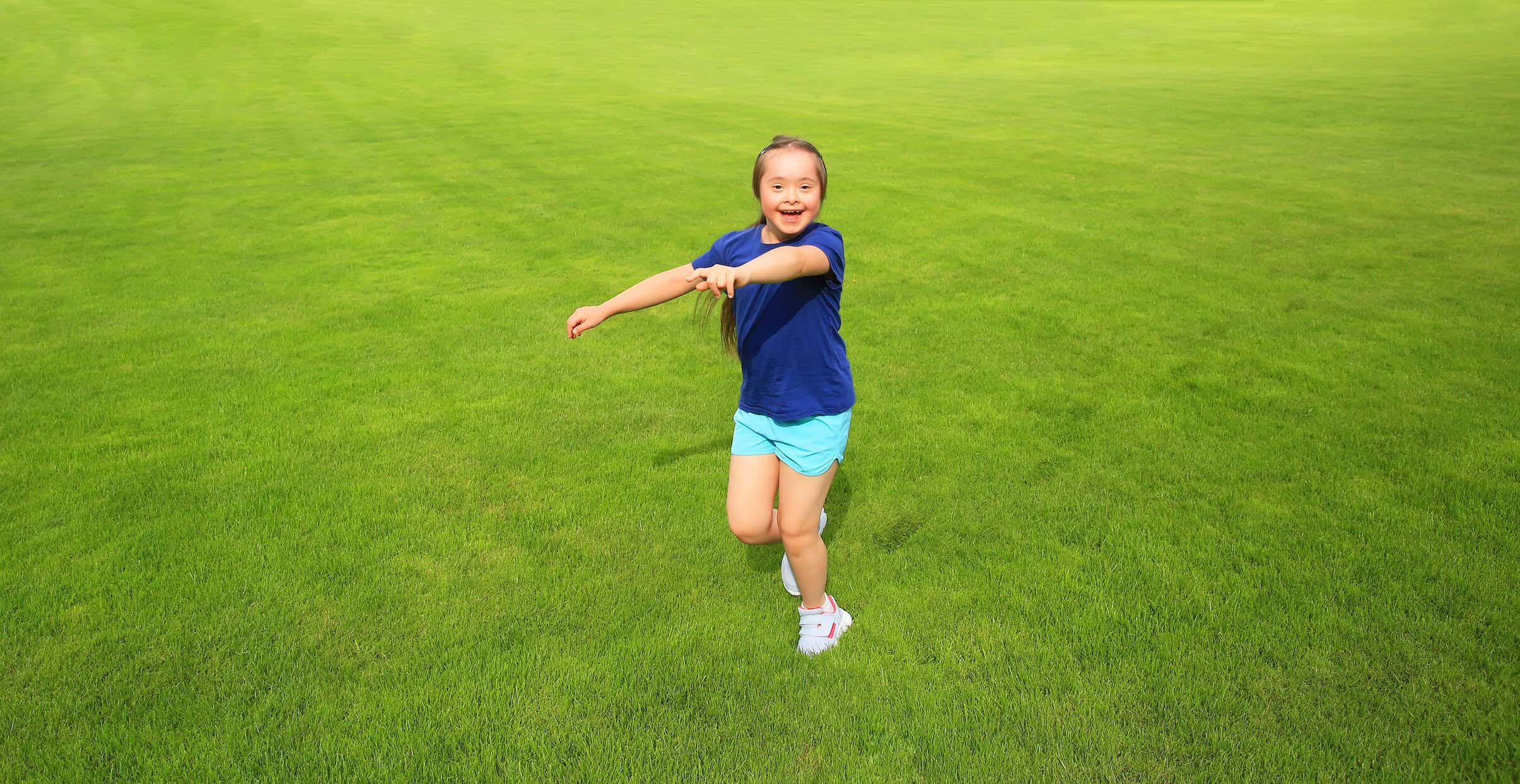 Girl running and smiling outdoors